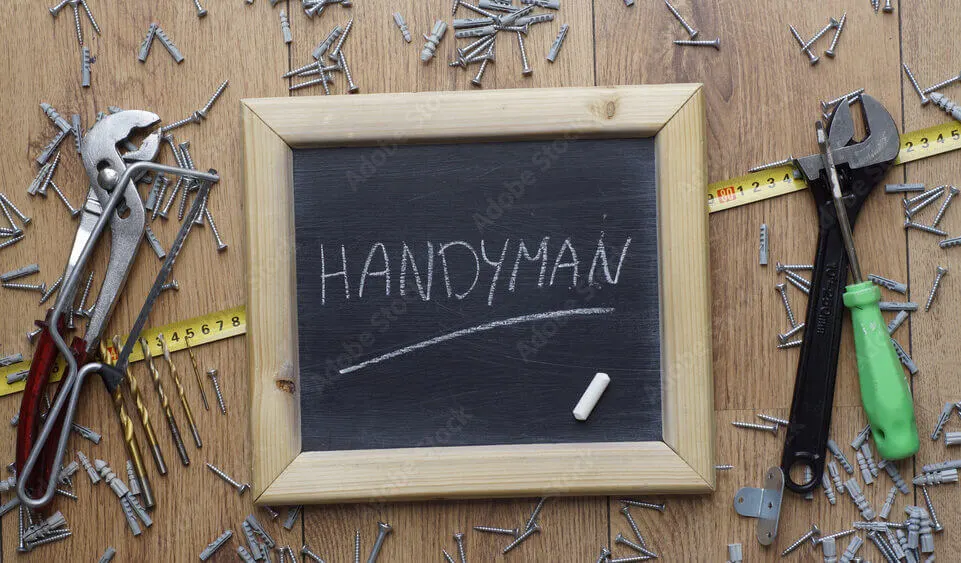 Handyman services in Dublin: Chalkboard with "HANDYMAN" written on it, surrounded by tools and screws.