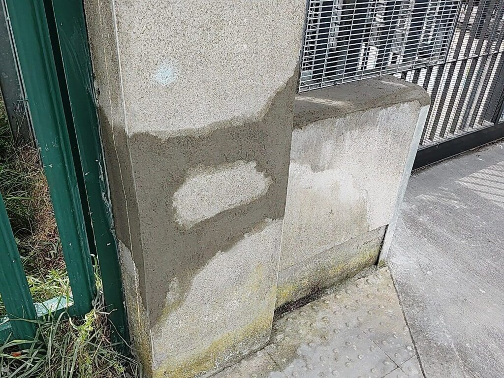 Repaired concrete pillar showing patch work. This wall repair in Dublin is now ready for painting.