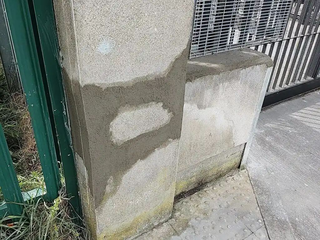 Repaired concrete pillar showing patch work. This wall repair in Dublin is now ready for painting.