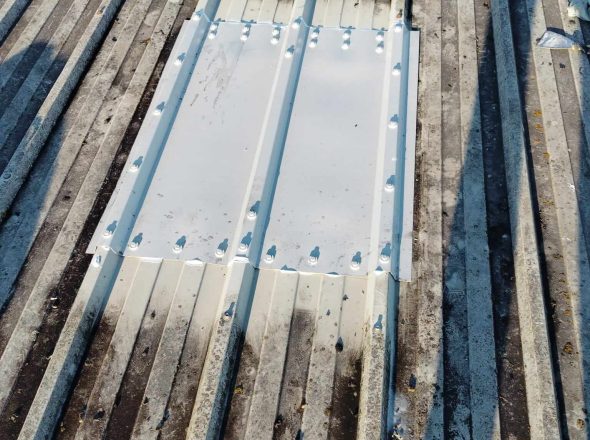 Repaired corrugated metal roof section, showcasing handyman jobs in Dublin with new metal sheeting.